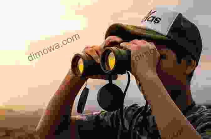 A Person Holding A Pair Of Binoculars And Observing Birds In The Wild AVITOPIA Birds Of Oman